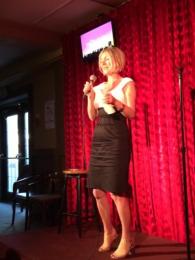 Photo of lolly b doing standup in front of red curtain